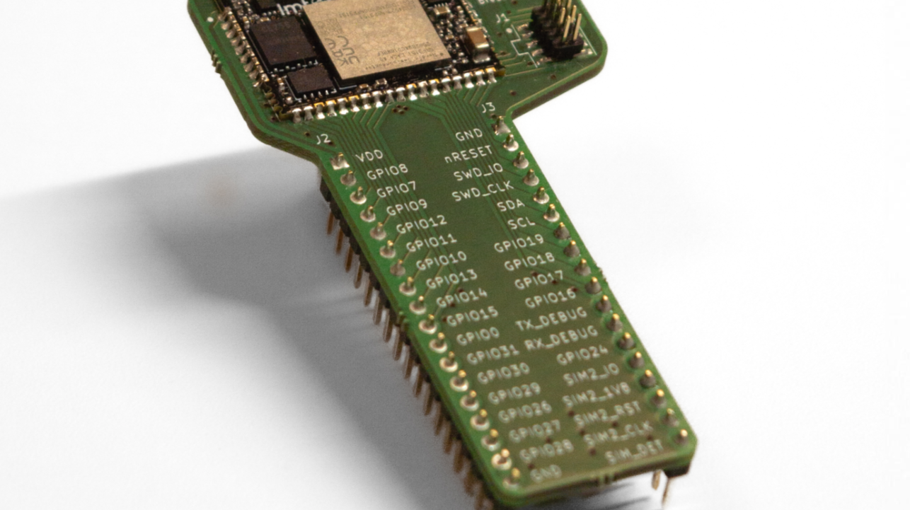 Close-up of PCB test pins on an evaluation kit carrier board used for debugging, programming, and hardware validation.