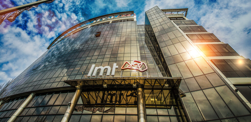 LMT Group office building with the company logo on a glass facade.